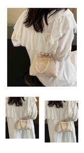 Detail of vintage cream lace embroidery bag with double pearl clasp and pearl chain