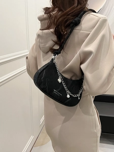 Black crescent shoulder bag with ruched texture, silver chain and heart charm