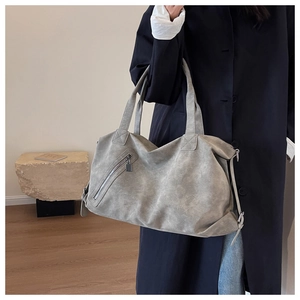 Macro shot of grey washed leather tote bag with vintage texture and zipper detail