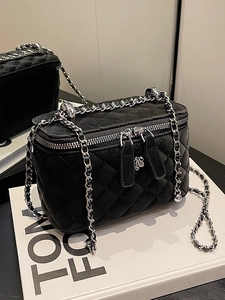 Quilted black mini chain box bag with silver flower charm on a white display