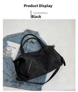 Detail of black tote bag with suede texture and metallic side zipper pocket