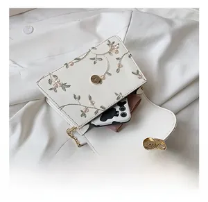 Internal view of embroidered lace bag showing capacity for phone and wallet with chain strap