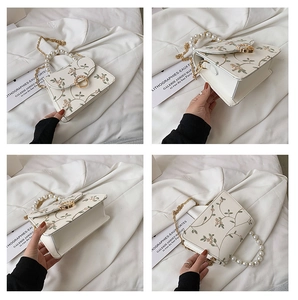 Detailed views of floral embroidery, pearl handle, and gold chain on the small white bag