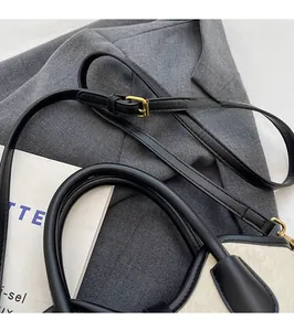 Detail of contrast bucket bag with star geometric embossing and golden hardware