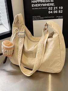 Minimalist beige oxford nylon tote bag with pleated texture and adjustable strap