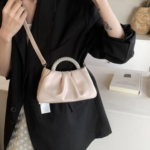 Elegant pearl handle cloud bag in pearlescent beige leather with a ruched finish