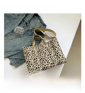 Detailed view of leopard print quilted tote bag with stitching and beige handles