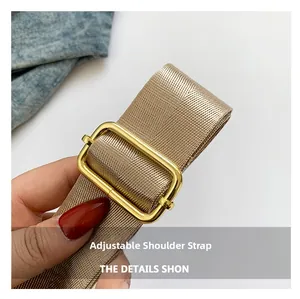 Detailed view of the woven adjustable shoulder strap with premium golden metal buckle