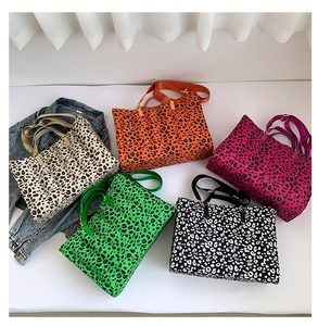 Flat lay of colorful leopard print quilted tote bags with adjustable wide shoulder straps