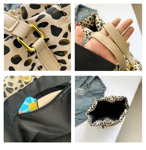 Detail view of leopard print tote featuring beige leather handles and gold metal hardware