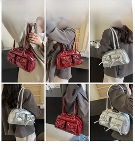 Detail view of bow pockets on burgundy and silver balletcore style shoulder bags