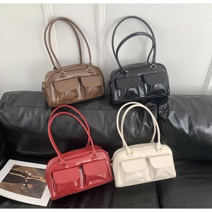 Detailed view of four retro PU leather shoulder bags in brown black red and white colors
