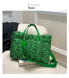 Detail view of large green leopard print tote bag with quilted fabric and gold hardware