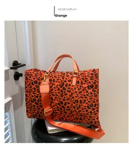 Detail of orange leopard print quilted tote bag with detachable wide fabric shoulder strap