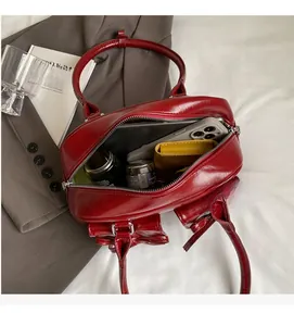 Top view of red patent leather Boston bag showing spacious interior with personal essentials
