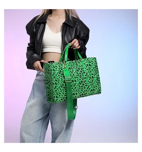 Macro shot of neon green leopard print tote bag with adjustable wide fabric shoulder strap
