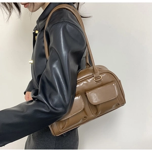 Brown PU leather shoulder bag with double pockets and gold hardware shown on a model