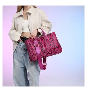 Detail shot of the pink leopard print tote bag featuring a matching wide nylon strap and buckle