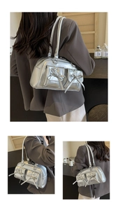 Detailed close-up showing metallic silver PU leather finish and ribbon bow pockets on the bag