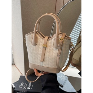 Fashionable beige houndstooth bucket bag with leather trim and gold-tone hardware