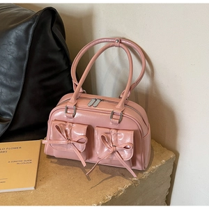 Detailed close-up of pink PU leather ballet style shoulder bag with ribbon bow pockets