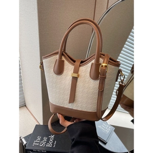 Contrast color bucket bag with white houndstooth texture and brown leather trim for women