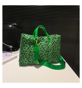 Detailed shot of green leopard print quilted tote bag with golden hardware and strap