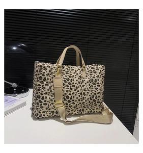 Detail of leopard print tote bag with quilted texture and adjustable fabric strap