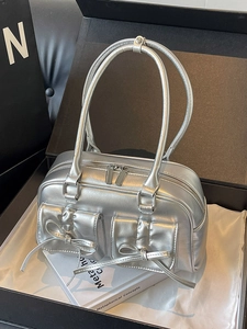 Metallic silver PU hobo bag with ballet-style bow pockets and sleek shoulder straps