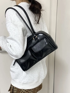 Minimalist black PU leather shoulder bag with dual front pockets and long straps