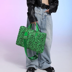 Large green leopard print tote bag with quilted texture and adjustable shoulder strap