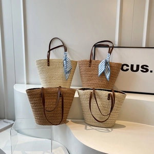 Summer straw tote bag with leather handles and decorative scarf for beach vacation style