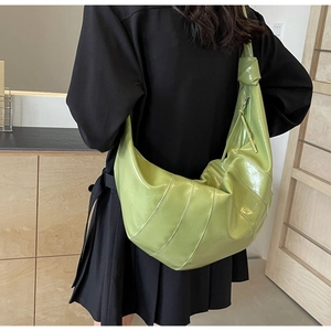 Detailed back view of a large avocado green croissant bag with knotted shoulder strap