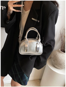 Detailed view of the silver glossy mini bowling bag with dual handles and metallic finish