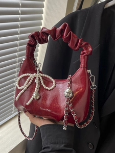 Elegant burgundy pleated cloud bag with pearl bow and heart charm on silver chain strap