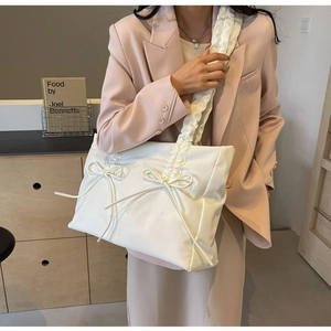 Cream white tote bag with bow detail and pleated shoulder strap for daily use
