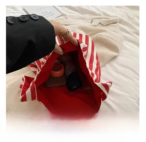 Interior view of red striped canvas tote bag showing large capacity for essentials