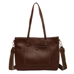 Minimalist brown faux leather tote bag with white contrast stitching and wide strap