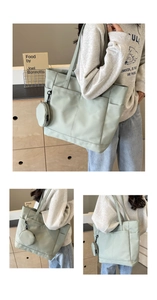 Detailansicht der mintgrünen Nylon-Tragetasche mit Vordertaschen und rundem Reißverschluss