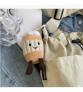 Detail of coffee cup plush charm with embroidery hanging on beige nylon tote bag