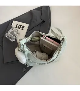 Spacious mint green shoulder bag with metallic chain and stylish crackle texture details
