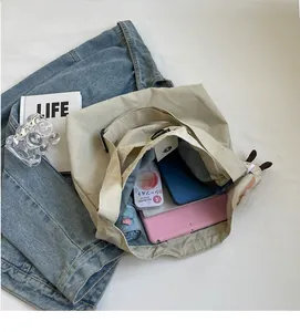 Top view of spacious nylon tote bag interior showing capacity for tablets and daily items
