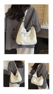 Detail of white pleated fabric shoulder bag with silver chain and plush cloud charm