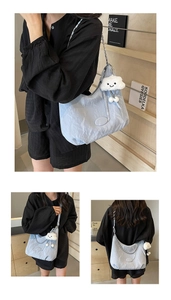 Detailed view of light blue wrinkled texture shoulder bag with cute cloud charm