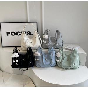 Detail showing high-gloss pleated hobo bags with 3D butterfly charms and cloud pendants