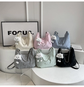 Collection of six pleated half-moon bags with chain straps and plush cloud charms