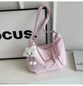 Pink pleated crossbody bag with silver chain and white cloud charm on white background