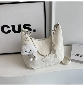 Detail of off-white pleated leather shoulder bag with silver chain and cloud charm