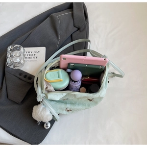 Detail view of large mint nylon backpack showing organized interior storage for tablet and items