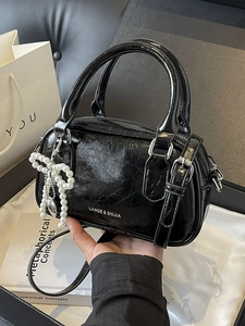 Chic black oil wax leather boston bag with pearl bow charm and adjustable strap